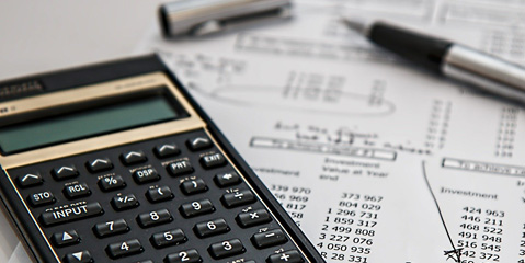 A calculator and paper running the numbers for financing